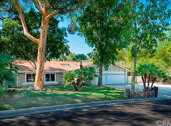 Another front perspective flaunting the front yard landscape, a new roof and a sky light above the f