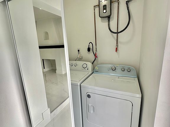 Entrance closet with water heater, washing machine & dryer