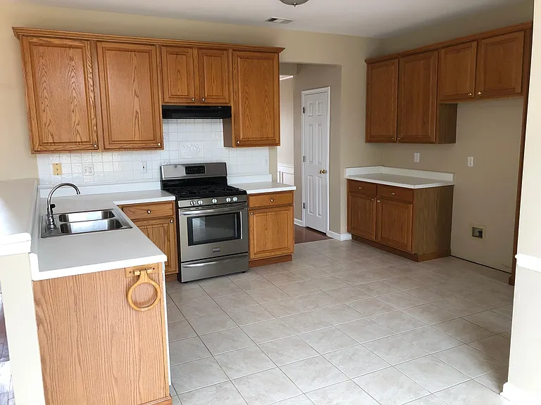 Large Gourmet Kitchen with breakfast bar and 3 pantries.
Stainless steel refrigerator optional