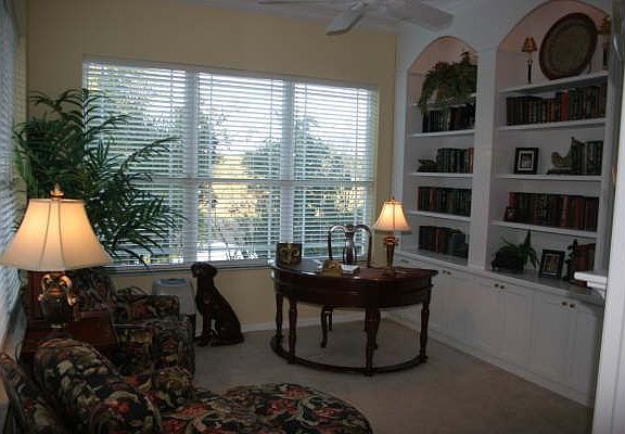Conservatory with custom built-ins and serene views!