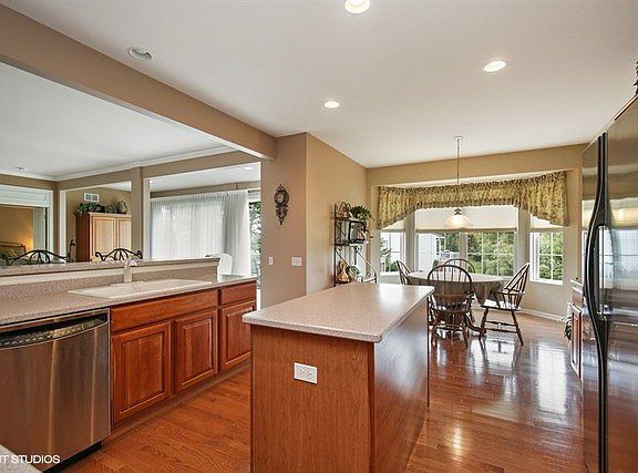 Cook's Dream Kitchen features Hardwood Floors, Cherry Cabinets, Corian Counters and newer Stainless Steel Appliances