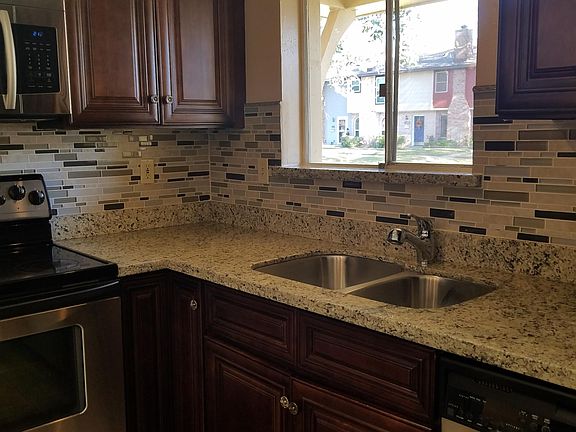 This shows the space saving overhead microwave, the glasstop stove, the lovely deep sink, and another picture of the granite window sill.