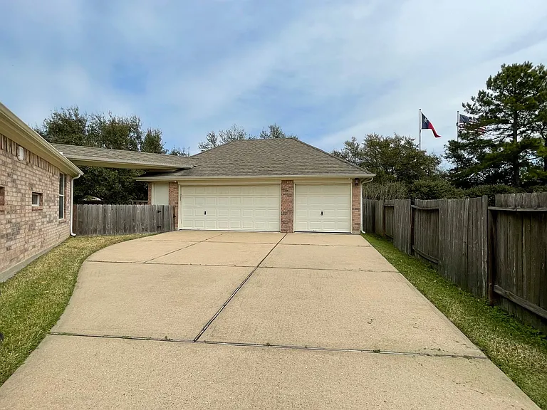 3-car detached garage with an extra-long, wide driveway_ideal for multiple vehicles and guests.
