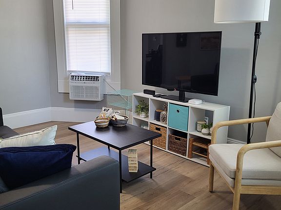 Seating area with Roku TV for streaming and dimmable reading lamp.