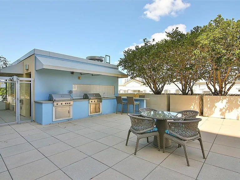 Outdoor grill and dining area for tenant use.