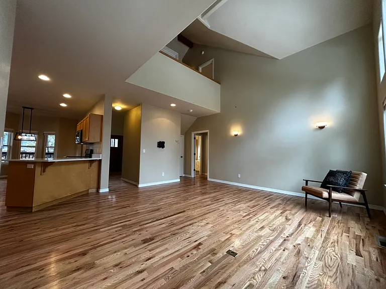 Living room looking toward entry to primary bedroom.