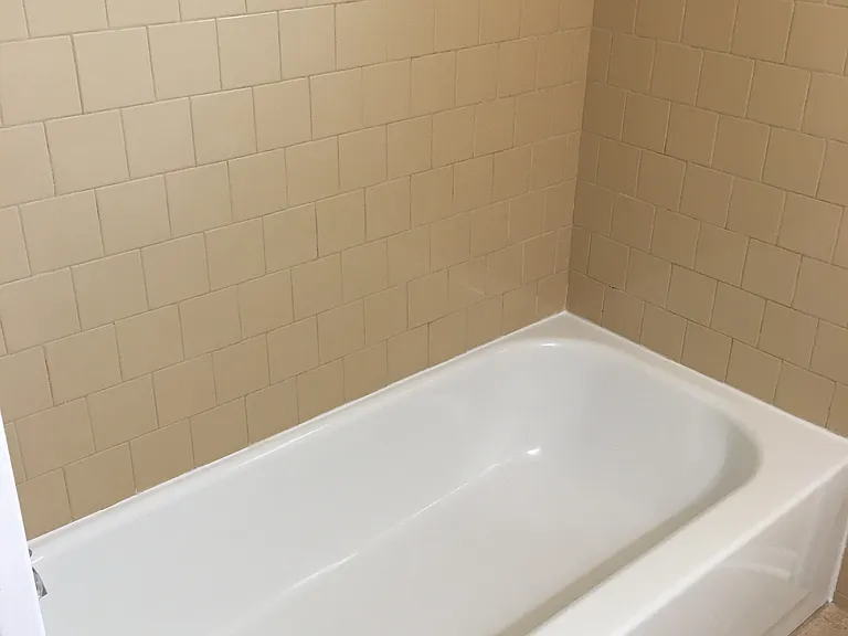 Tiled bath surround and refinished tub.