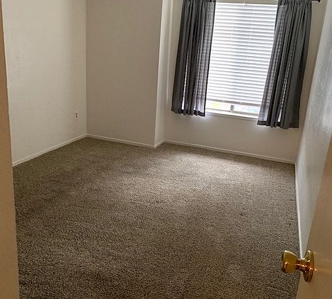 one of two bedrooms, each has a closet and window/ blinds