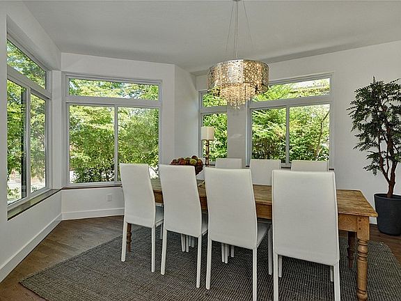 Dining room with bright, territorial outlook, circular floor plan through to Butlers pantry and kitchen. Kovacs Chandelier.