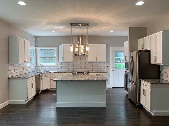 Renovated kitchen with high end cabinetry, granite counters, stainless appliances including a wine cooler.