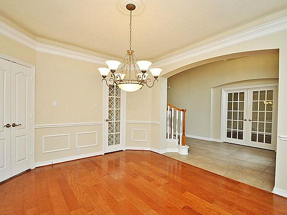 Hardwood flooring installed two weeks ago. Never lived on. Double doors bring you to the kitchen.Crown molding with rope lighting.