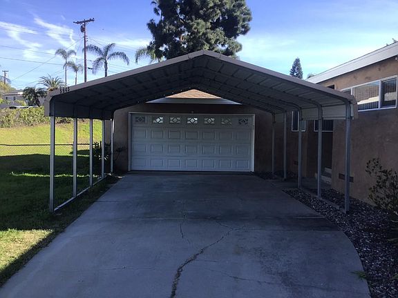 additional large two car carport with two car garage with washer and dryer