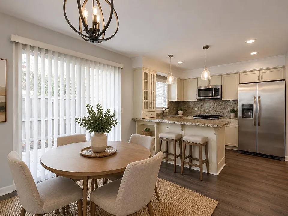 Open-concept dining area conveniently connected to the kitchen, creating a functional and welcoming layout. Photos are virtually staged.