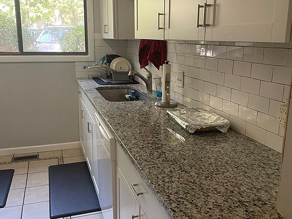 Large farm sink and granite countertops. Fully stocked kitchen.