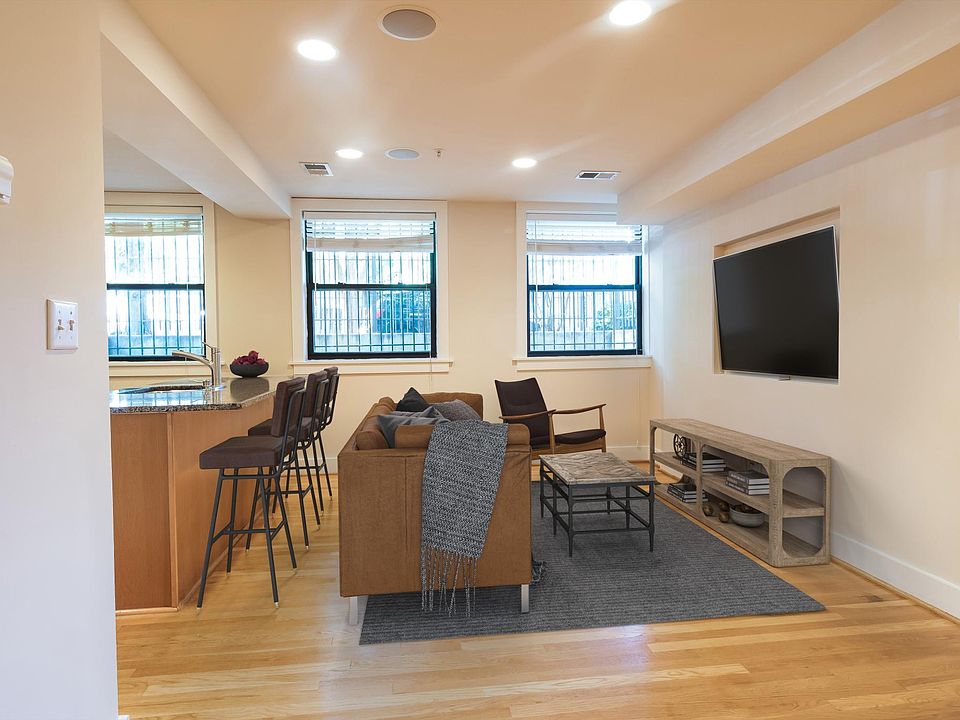Den with great light and area for TV. Seating at counter. (Virtually Staged.)