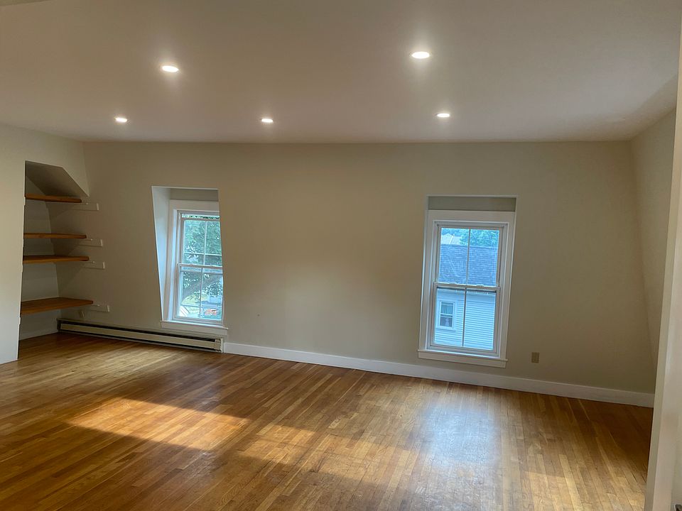 Open sunny living/dining room with new lighting.