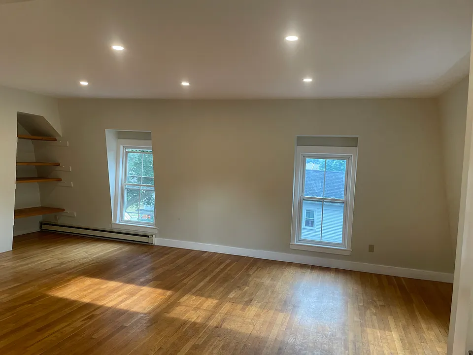 Open sunny living/dining room with new lighting.