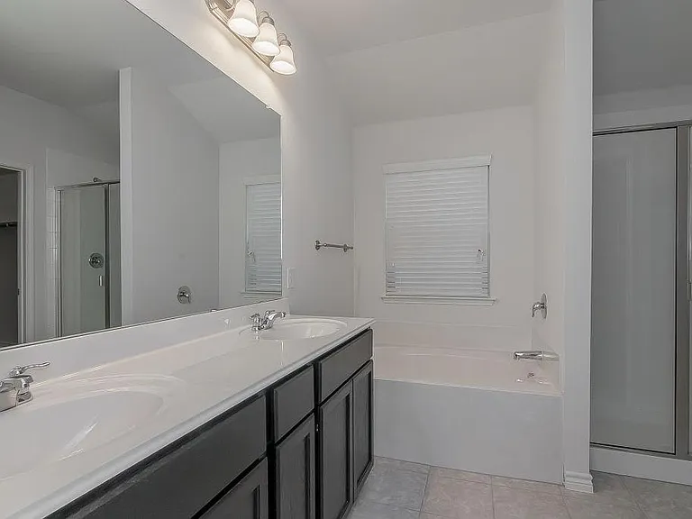 Master Bath with dual sink, tub and separate shower.
