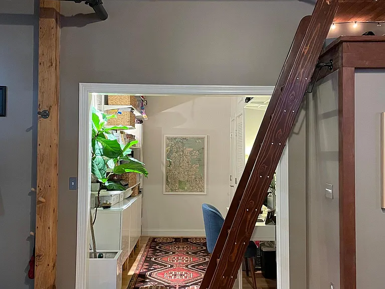Lofted storage area accessible by built-in ladder