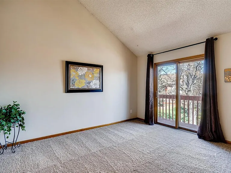 2nd bedroom with balcony, new carpets installed June 2025