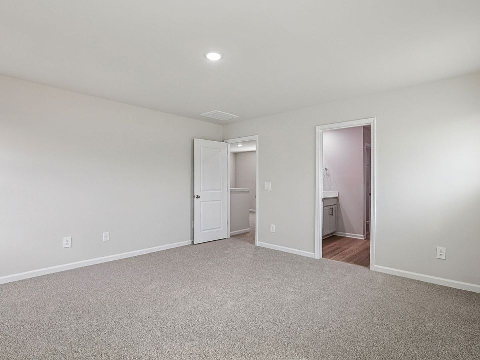 Primary bedroom in the Dallas floorplan at a Meritage Homes community in Garner, NC.