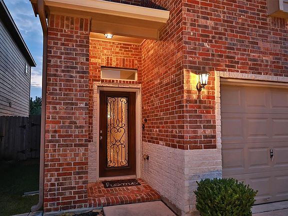 Upgraded front door with full rain glass and wrought iron.