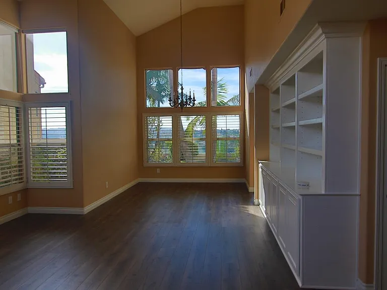 View (from foyer) of the living and dining with cathedral ceilings and built-in