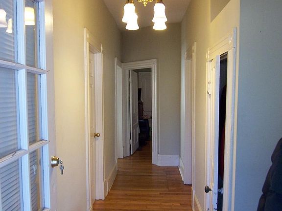 Foyer with coat closet and front bathroom and bedroom doors