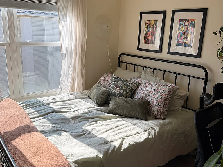 Second bedroom + home office includes a queen sized bed, desk, ergonomic desk chair, and closet. Large windows let in lots of natural light. This room also has a door to the patio.