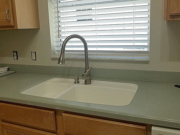 Corian counters and high arc sprayer faucet.
