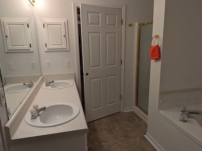 Bathroom #1 with double vanity, stall shower and spa tub.