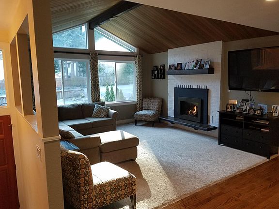 Open family room with gas fireplace and pre installed wall TV mount.