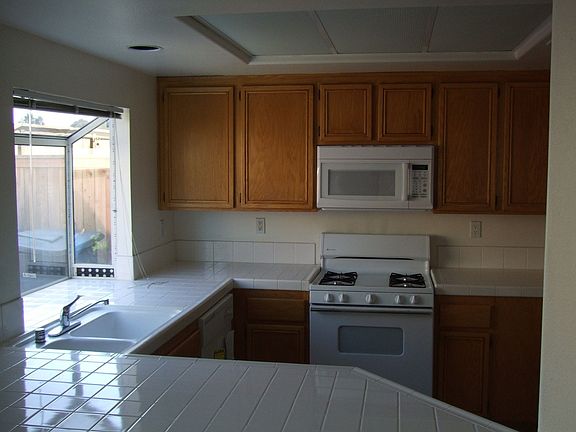 Bright sunny kitchen with new microwave and stove/oven