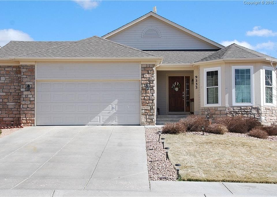 Ranch Home with extended garage and lovely rock veneer face!