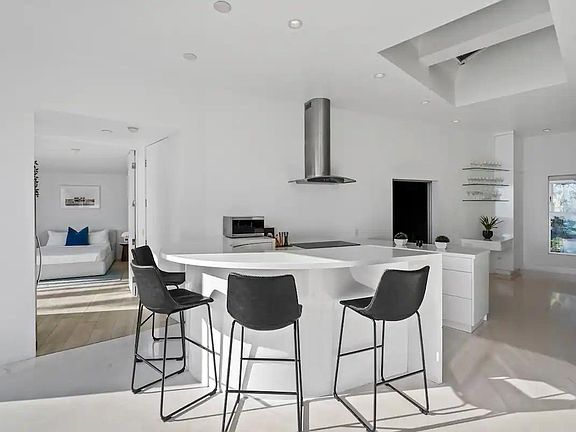 The kitchen's bar counter with four stools invites socializing and additional seating.