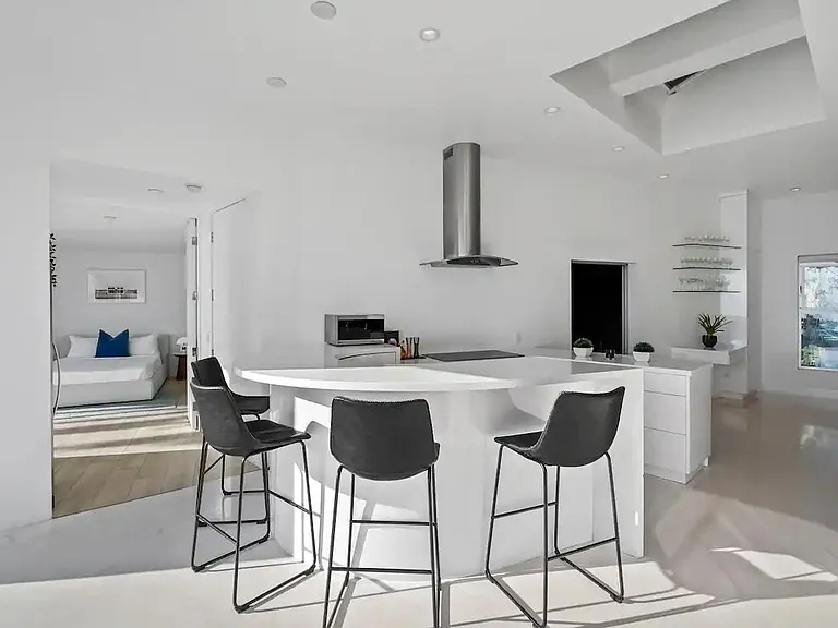 The kitchen's bar counter with four stools invites socializing and additional seating.