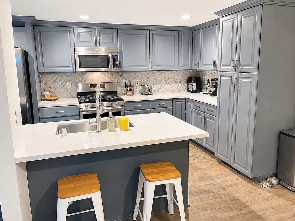 Kitchen with breakfast bar. Dining room / breakfast nook area behind camera / not pictured.