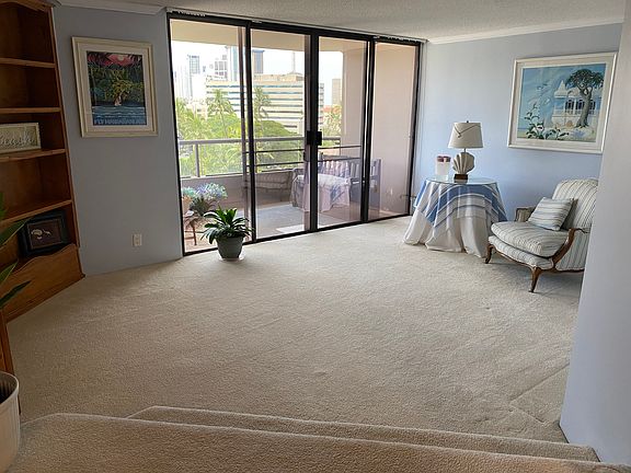 Living room with built in entertainment center and cabinet.