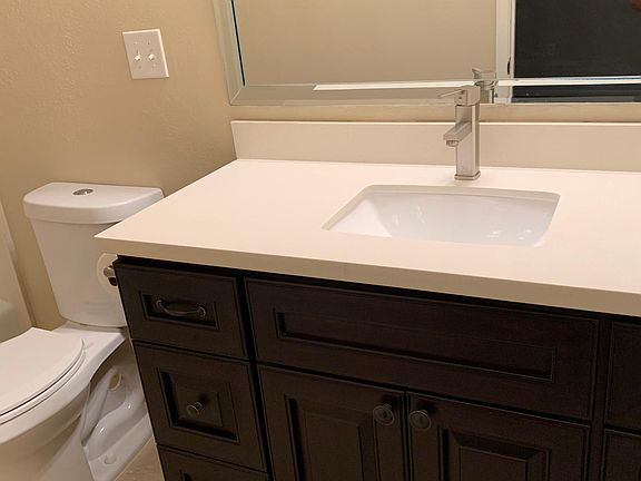 Second bathroom with high end vanity with self closing drawers and doors, quarts counter top