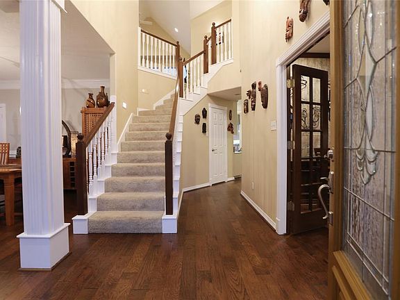 The 2 story foyer greets you as you enter the home. Warm wood floors continue through the first floor.