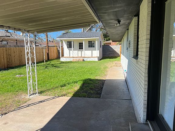 Fenced in back yard with shed.