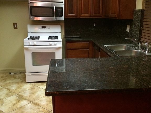 Roomy kitchen with wood blinds