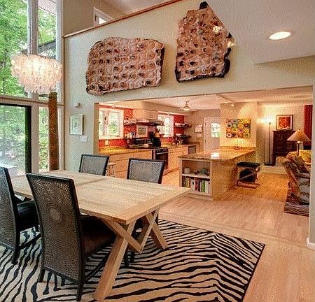 Wide open floor plan unites the dining room, kitchen and downstairs den.