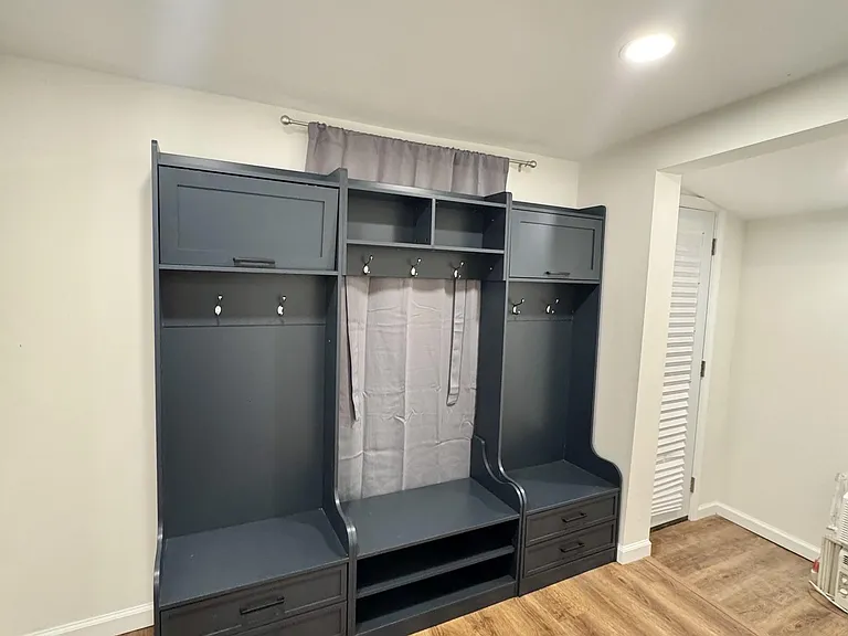 Functional entry/mudroom area with built-in bench seating, drawers, and coat hooks for convenient everyday storage.