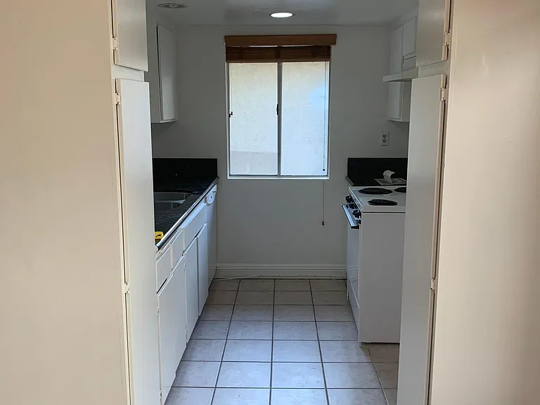 Kitchen w dish washer and garbage disposal.