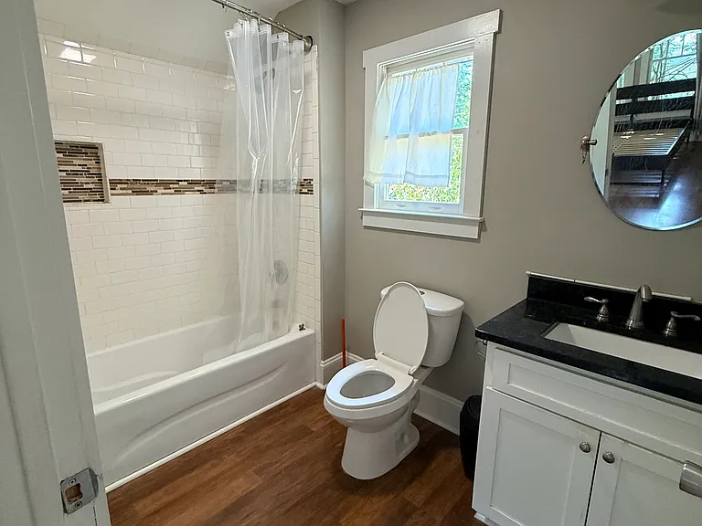 Full bathroom with closet space