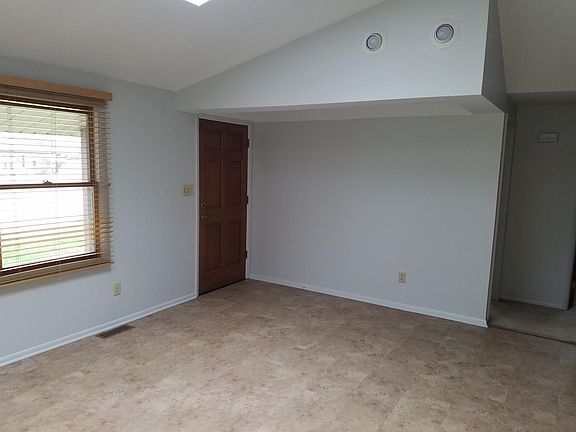 Front Living Room with Vaulted Ceiling and Skylights