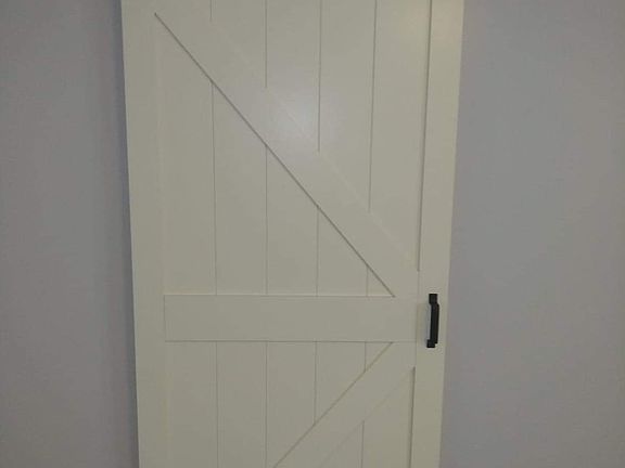 In Living Room Looking at Bedroom Sliding Barn Door