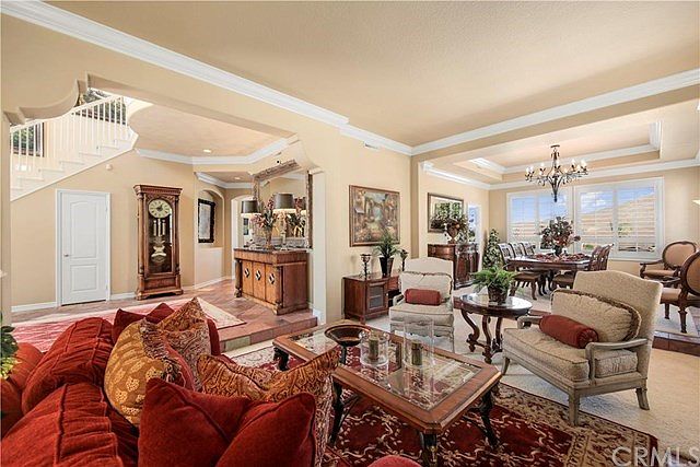 Living Room and Dining Room Combination, right off the Foyer that has a curved staircase and 2 story high ceilings with Turret,