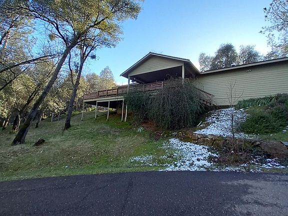 Front hillside and covered deck.